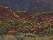 Jemez Morning #2 Painting by Brenda Howell showing red hills dotted with green shrubs in early morning light with lavendar cliffs in shadow in the background near Jemez Pueblo in New Mexico.